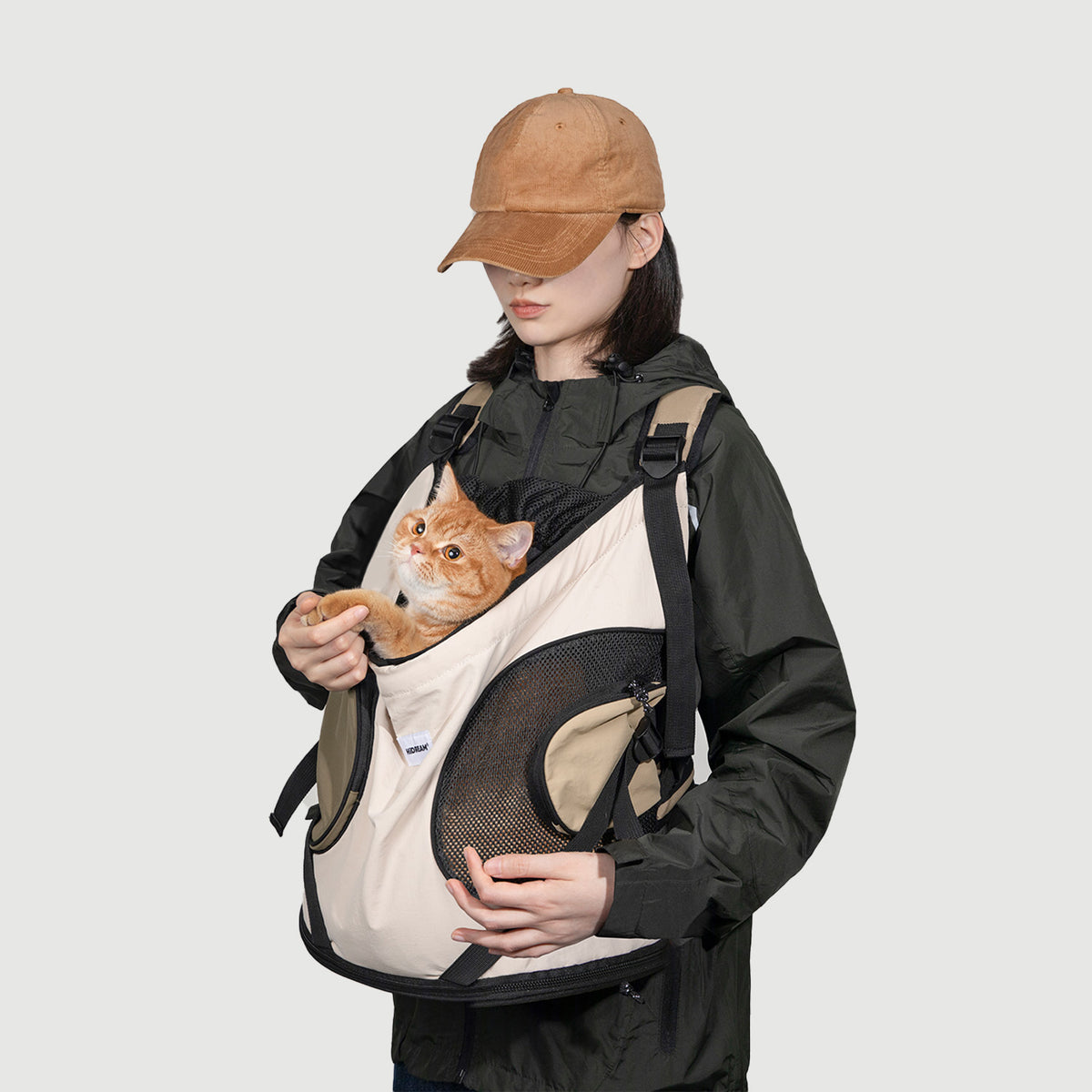 Front facing pet carrier worn on the chest with a small pet kept close and within view
