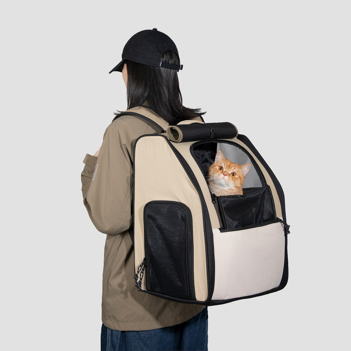 Person wearing a spacious pet carrier backpack with a small pet during travel